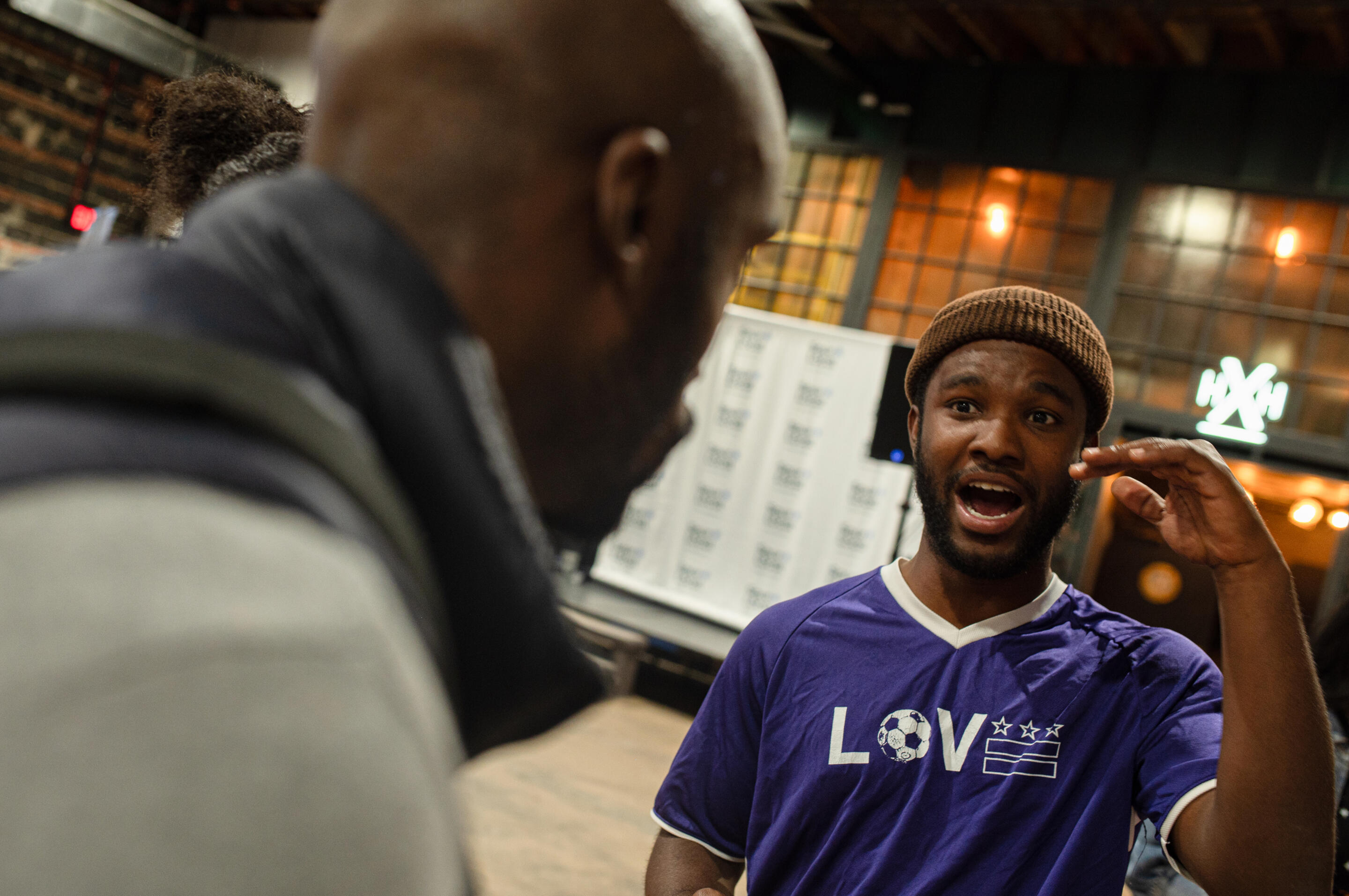 Photo at Spur Local's Community Changemakers 2025 event, showing a nonprofit person speaking with an event attendee. Photo courtesy of Fleur Louise Photography